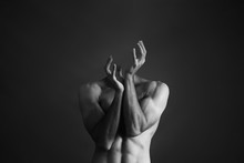 Decapitated Shirtless Man Against Gray Background