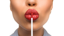 Woman Applying A Lip Gloss On Her Lips On White Background. Kissing.