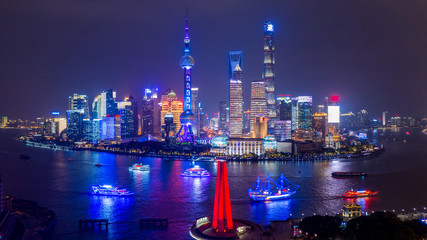 Wall Mural - Aerial view Shanghai city skyline and skyscraper, Shanghai modern city at night in China on the Huangpu River.