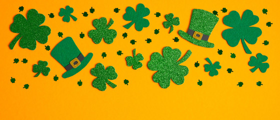st patricks day banner design with green shamrock and four-leaf clovers, irish elf hats, confetti. f