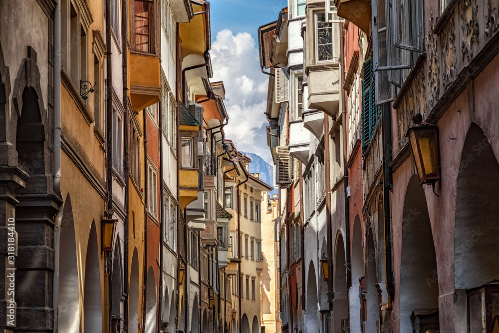 The famous road Via dei Portici with arcades on both sides in Bolzano, South Tyrol, Italy - obrazy, fototapety, plakaty 