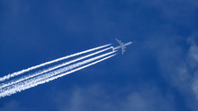 Low Angle View Of Airplane Flying Against Sky