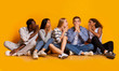 © Prostock-studio - Group of students gossiping over yellow background