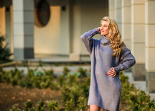 Enjoy The Silence. Free Style Comfortable. Autumn Fashion. Blond Girl Make Up Fall Outfit. Girl Soft Knitwear Dress. Cashmere Woolen Sweater. Warm Oversized Clothes. Sexy Woman Sunny Weather Outdoor