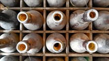 Directly Above Shot Of Old Dusty Bottles In Container