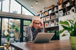 © bnenin - Worried mature woman looking at laptop at home, portrait.