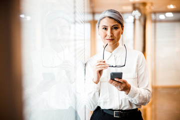 Wall Mural - Confident beautiful lady boss at work stock photo