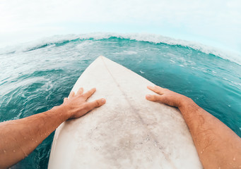 Wall Mural - Young man having fun surfing on high waves ocean - Sporty surfer doing training exercises on blue water - Extreme sport and health vacation lifestyle people