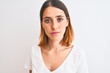 © Krakenimages.com - Beautiful redhead woman wearing casual white t-shirt over isolated background with a confident expression on smart face thinking serious