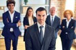 © Krakenimages.com - Group of business workers smiling happy and confident in a meeting. Standing with smile on face looking at camera at the office.