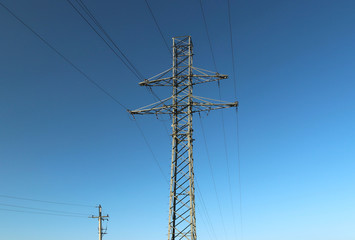 Electrical network of high voltage. Transportation of electricity through the high-voltage line. Metal tower with wires and cables. Clean country energy. Energy security. Work at height. Training matt