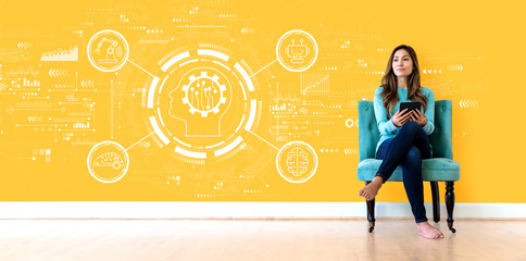 Wall Mural - Future technology concept with young woman holding a tablet computer