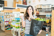 © AntonioDiaz - Happy Female Customer Standing In Grocery Store