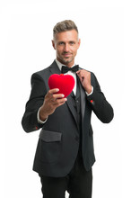 Celebrating Love. Tuxedo Man Red Valentines Heart. Ready For Romantic Date. Special Occasion. Elegant Confident Man Isolated On White. Businessman Formal Outfit. Love Symbol On Valentines Day