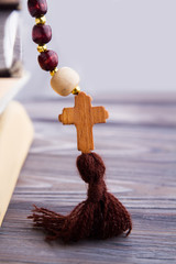 Wall Mural - Wooden christian cross on rosary. Close up.