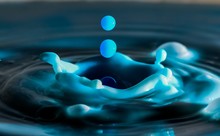 Blue Drops Splashing In Water