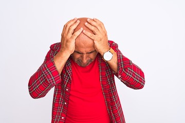 Middle age handsome man wearing casual shirt standing over isolated white background suffering from headache desperate and stressed because pain and migraine. Hands on head.