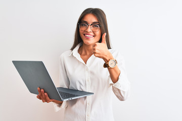 Poster - Beautiful businesswoman wearing glasses using laptop over isolated white background happy with big smile doing ok sign, thumb up with fingers, excellent sign