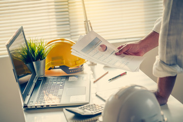 Hand of Business people working document about budget profits and planning of construciton project