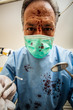 © Minerva Studio - Mad dentist with a blood stained cloth torturing a patient, pov shot