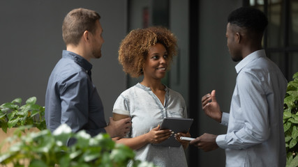 Wall Mural - multiethnic coworkers talk discussing business ideas in office