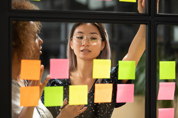 Wall Mural - asian female employee work with sticky notes in office