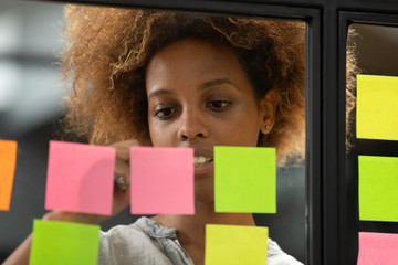 Wall Mural - close up of biracial employee working with colorful stickers