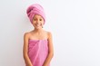 © Krakenimages.com - Beautiful child girl wearing shower towel after bath standing over isolated white background with a happy and cool smile on face. Lucky person.