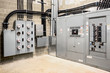 © Petra Richli - Electrical room of residential or commercial building. Multiple smart meters, main power breaker, meter stacks and cabinets. Perspective view