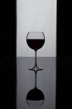 Glass With Wine. Black And White. Red Wine. Red Wine On A Black And White Background. Isolated Glass With Wine.