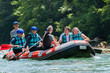 © cirkoglu - Rafting team goes down the river on the beautiful sunny day.