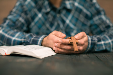 Poster - man hand wooden cross with Bible