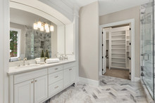 Master Bathroom In New Luxury Home With Double Vanity And View Of Walk-in Closet