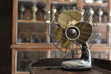 Close-Up Of Electric Fan On Table At Home