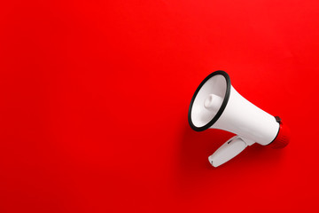 Modern megaphone on color background