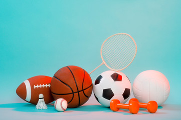 Wall Mural - Sports equipment, rackets and balls on blue background and copy space.