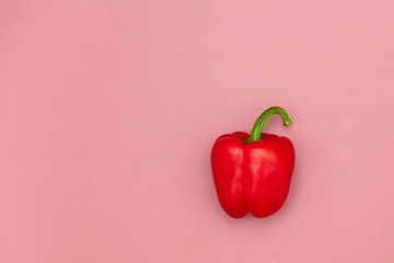 Fresh red pepper on pink background