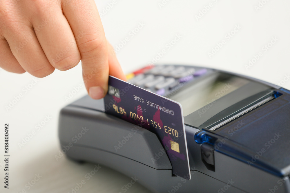 Woman using bank terminal for credit card payment, closeup