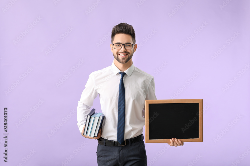 Male teacher with chalkboard on color background