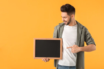 Sticker - Young man with chalkboard on color background