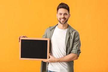 Sticker - Young man with chalkboard on color background