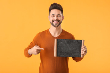 Sticker - Young man with chalkboard on color background