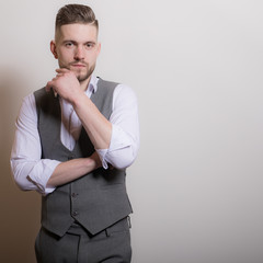 Handsome young elegant man studio portrait.