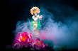© Snowbelle - Hindu god Krishna. Statue with a smoke and lotus flowers on a black background