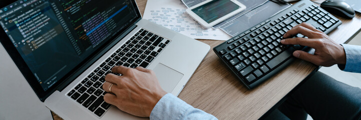 programmer typing code on desktop computer, developing programming and coding technologies concept.