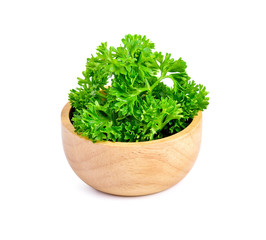 Sticker - parsley in wooden bowl isolated on white background.