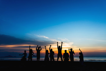 Wall Mural - Summer activity lifestyle silhouette group of friends or traveler joy fun jumping on beach at sunset, Leisure tourist people travel Thailand holiday vacation trips, Tourism beautiful destination Asia