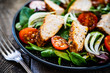 © Jacek Chabraszewski - Caesar salad - barbecue chicken breast and vegetables on wooden table