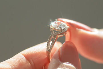 Wall Mural - Close-up view of diamond ring and woman hand