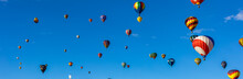 Low Angle View Of Hot Air Balloons Flying Against Blue Sky